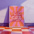 Retro-style poster with psychedelic 1970s-inspired design. Text reads "WEIRD GIRLS DO IT BETTER" in wavy, groovy lettering. Pink and orange sunburst background. Centered text surrounded by curved rays. Bold red frame with scalloped edges. Vibrant colors and playful typography create a vintage hippie vibe. Square format print with rounded corners. Perfect for fans of retro aesthetics and empowering slogans.